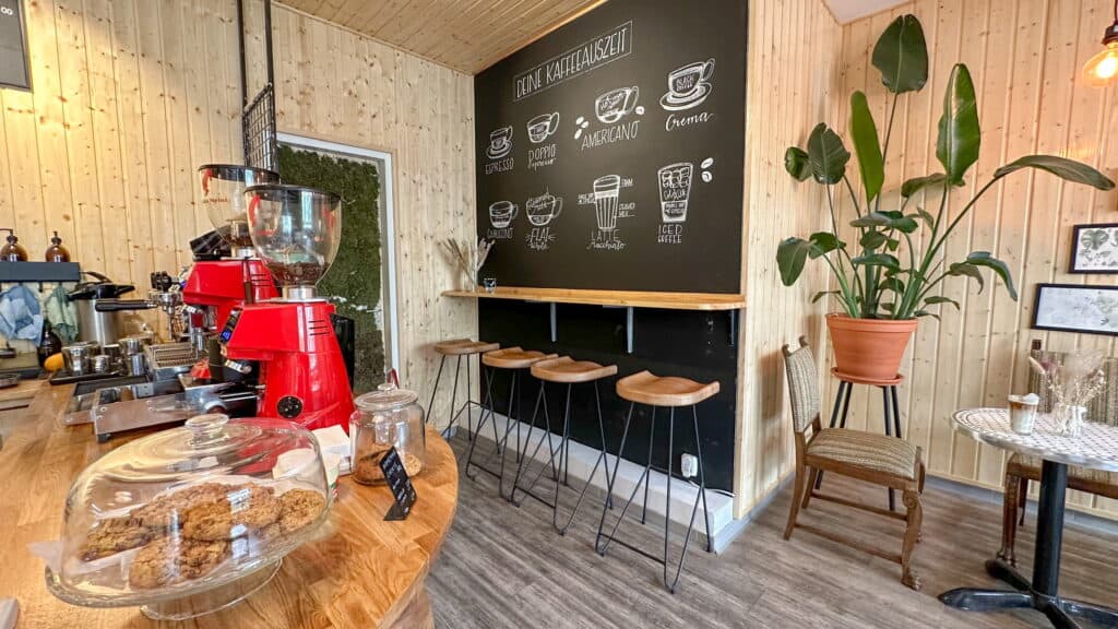 Café im Innenraum und Sitzgelegenheit mit Hochstühlen.